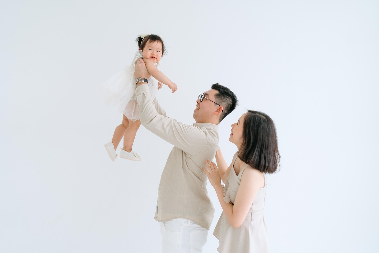 Toddler seated on a hip seat carrier